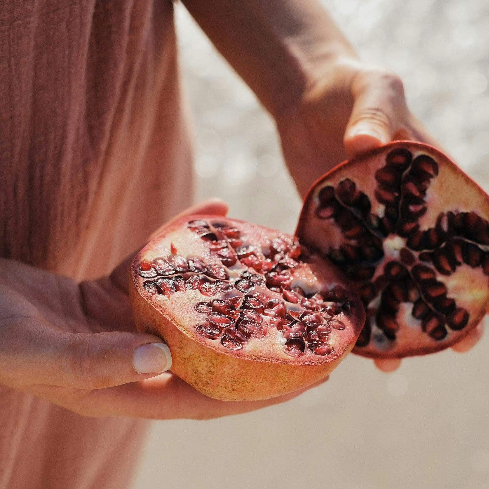 woman with pomegranate symbol of fertility